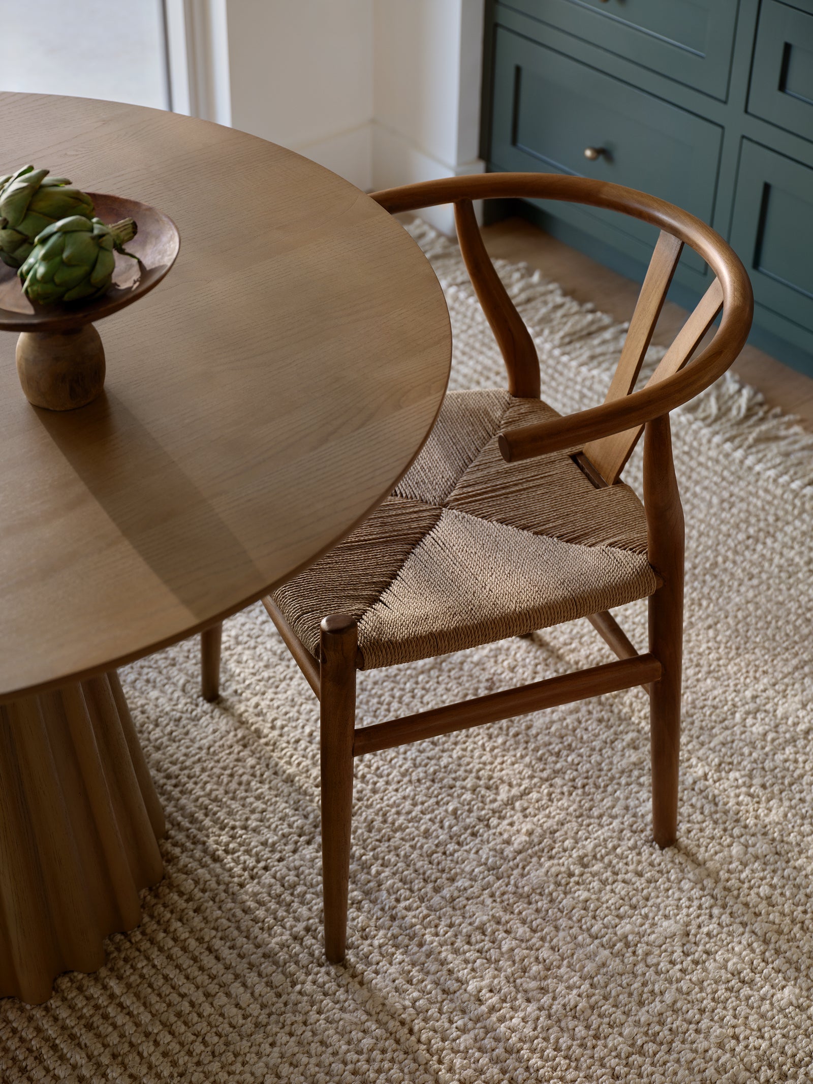 Jute rug in kitchen area with dining table and chair